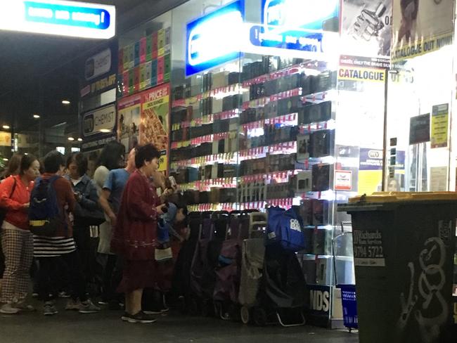 Shoppers queue for baby formula delivery at My Chemist on Elizabeth St before the store opens.