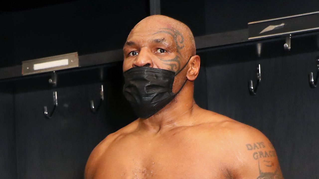 Mike Tyson celebrates after a split draw against Roy Jones Jr.