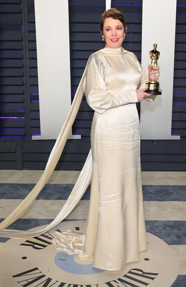 Best Actress winner Olivia Colman holds on tightly to her Oscar as she arrives at the party. Picture: AFP