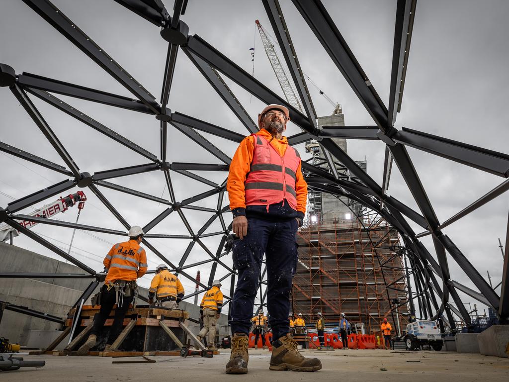 Westgate Tunnel portal towers. Construction worker Sam Rizza stands inside the geometrical framing of the portal tower. Picture: Jake Nowakowski