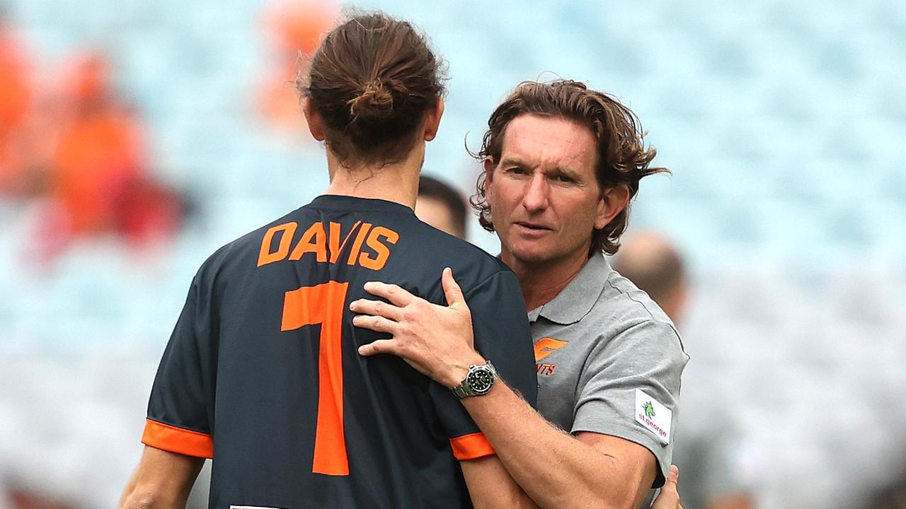 James Hird embraces Phil Davis before a Giants game.