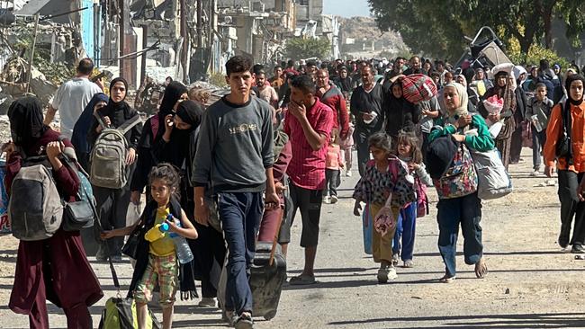 Displaced families fleeing Israeli army operations in Jabalia in northern Gaza take the main Salah al-Din road towards Gaza City on October 23, 2024 amid the ongoing war in the Palestinian territory between Israel and the Palestinian Hamas group. (Photo by AFP)