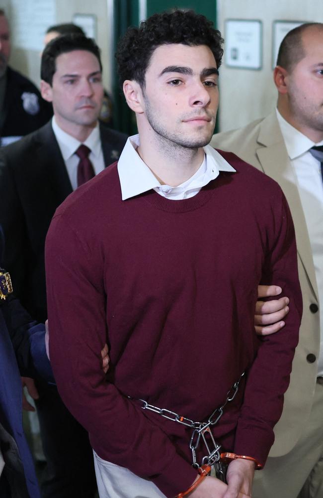 Luigi Nicholas Mangione (C) arrives at Manhattan Criminal Court in New York on December 23, 2024. (Photo by CHARLY TRIBALLEAU / AFP)