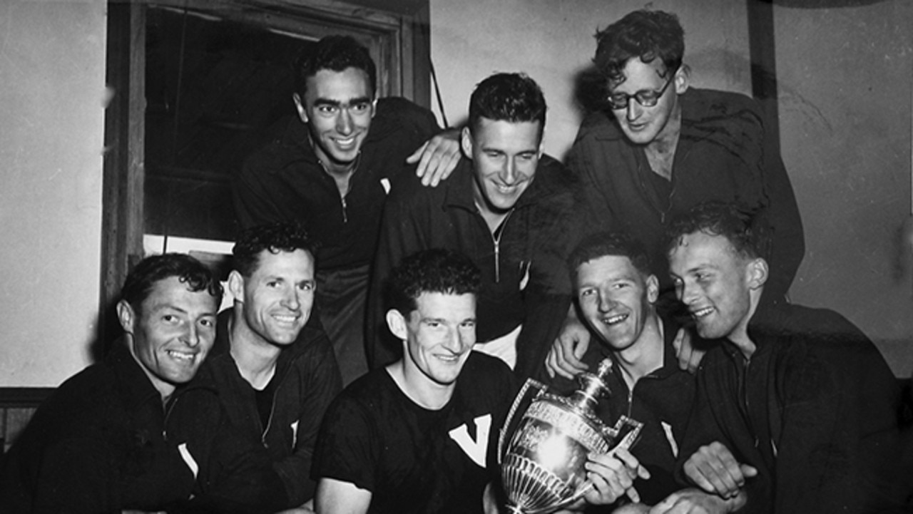 Olympic bronze medallist and rowing icon Garth Manton is being remembered as an "icon" on the water and footy field following his death, aged 93. He was a long-time member of the Mercantile Rowing Club and supported the Geelong Grammar rowing team. Garth is the second seated man from the right holding the trophy. Picture: Supplied