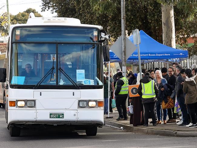 MELBOURNE, AUSTRALIA - NewsWire Photos JUNE 24, 2023: Transport disruption across Melbourne for the next two weeks as work on the West Gate Tunnel Project limits the train network and blocks major roads to the western suburbs. Commuters wait for a bus outside Newport train station. Picture: NCA NewsWire / Ian Currie