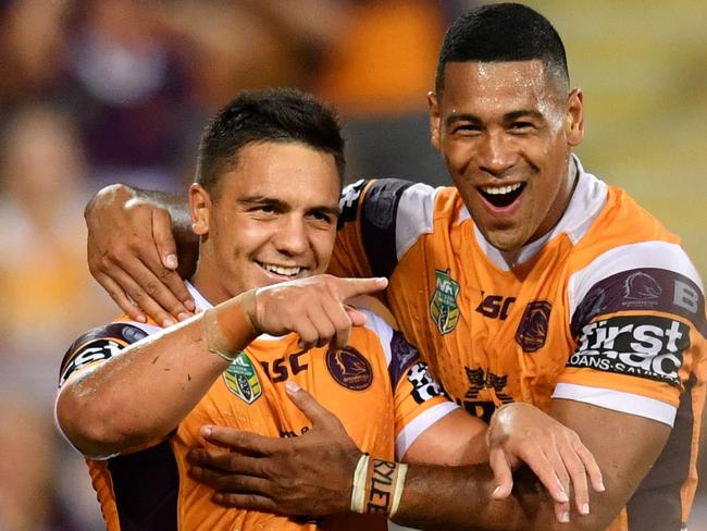 Kodi Nikorima celebrates scoring a try with Jamayne Isaako.