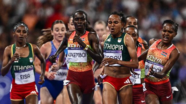 Kipyegon on the inside tangled with Tsegay. (Photo by Jewel SAMAD / AFP)