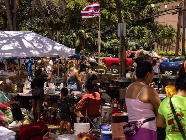 Hawaii’s flag waves at a distribution centre at Honokawai Beach Park in Napili-Honokowai, west of Maui, Hawaii. Picture: AFP