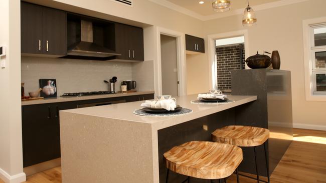 The kitchen has a walk-in pantry and island bench.