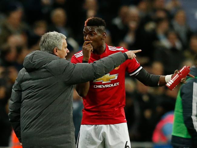 Jose Mourinho talks with Paul Pogba after the second Tottenham goal goes in.