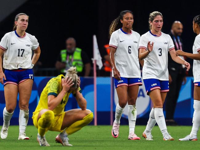 Australia's defender #14 Alanna Kennedy reacts as US' players celebrate at the end of the women's group B football match between Australia and the USA of the Paris 2024 Olympic Games at the Marseille Stadium in Marseille on July 31, 2024. (Photo by Pascal GUYOT / AFP)