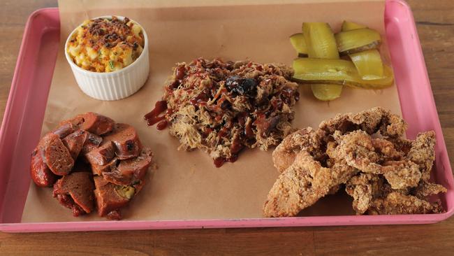 Jalapeño and cheddar hot links, pulled pork, "taxi fries" (deep fried chicken skin), Mac &amp; Cheese with brisket and in-house pickles at Proof BBQ &amp; Booze. Picture: Mark Cranitch