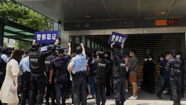 People gather at the Evergrande headquarters in Shenzhen, as the Chinese property giant said it was facing ‘unprecedented difficulties’ but denied rumours that it is about to go under. Picture: Noel Celis/AFP