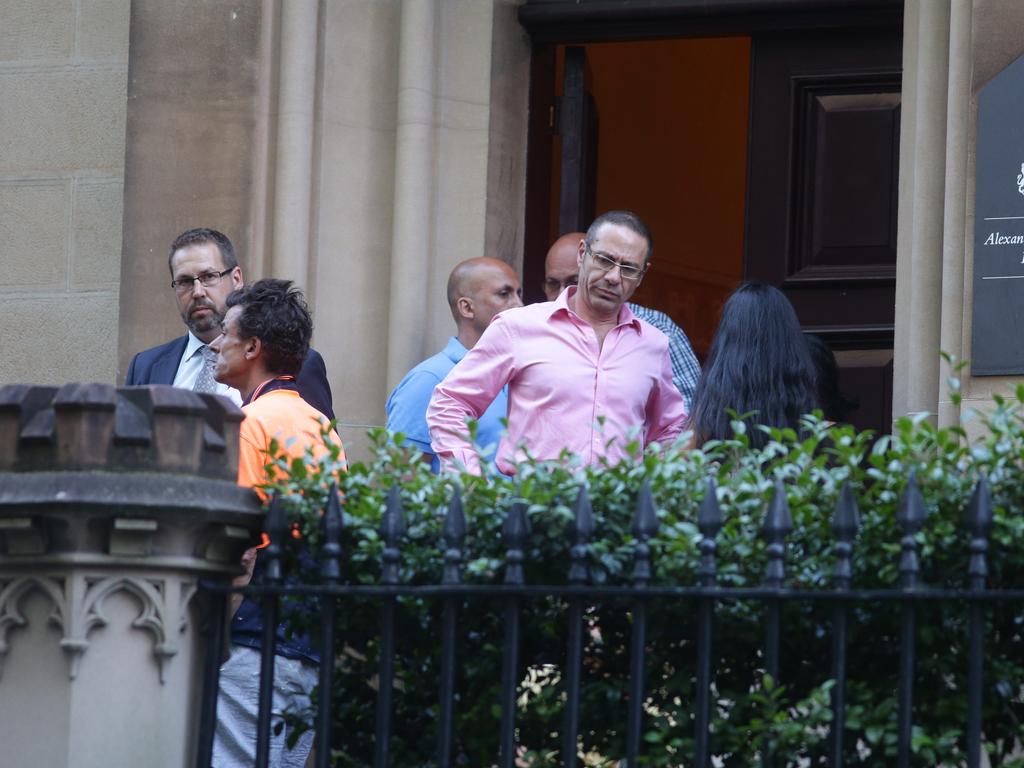 People believed to be family and friends of hostages gather with police near the Martin Place siege. Picture: Cameron Richardson