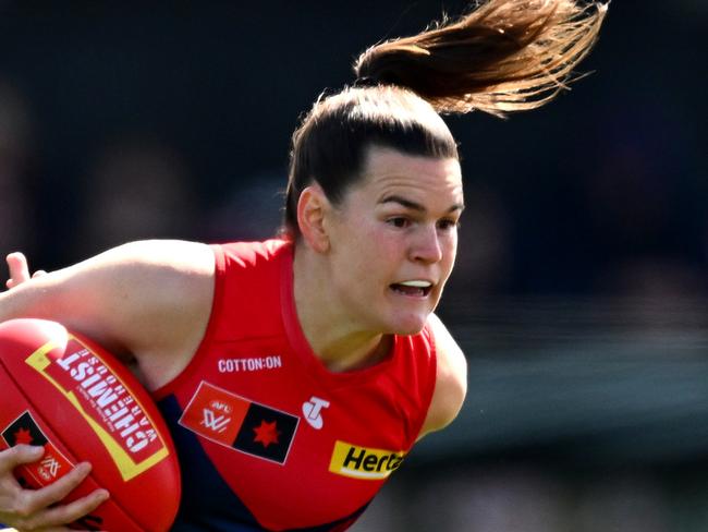 MELBOURNE, AUSTRALIA - SEPTEMBER 15: Lily Mithen of the Demons is tackled during the round three AFLW match between Melbourne Demons and North Melbourne Kangaroos at Casey Fields, on September 15, 2024, in Melbourne, Australia. (Photo by Quinn Rooney/Getty Images)