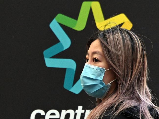 A woman waits in a queue to receive benefit payouts, including unemployment and small business support, at a Centerlink payment centre in downtown Sydney on April 14, 2020. - Australia's unemployment rate is expected to soar from 5.1 percent to 10 percent in the June quarter as the coronavirus fallout hits the economy, according to Treasury figures released on April 14. (Photo by Saeed KHAN / AFP)