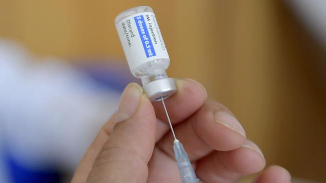 A Tunisian nurse prepares a dose of the Johnson & Johnson coronavirus vaccine at El-Menzah Stadium which was turned into a vaccination centre in the capital Tunis on August 3, 2021. - Tunisia -- which has seen the world's worst Covid-19 death toll -- may be over the peak of the latest wave but the government must still speed up inoculations, the WHO said on August 2, 2021. But with vaccines in short supply, overwhelmed hospitals, shortages of oxygen and the highly contagious Delta variant rampaging through the country's 12 million population mean the risk of a health disaster remains, the WHO warned. (Photo by FETHI BELAID / AFP)