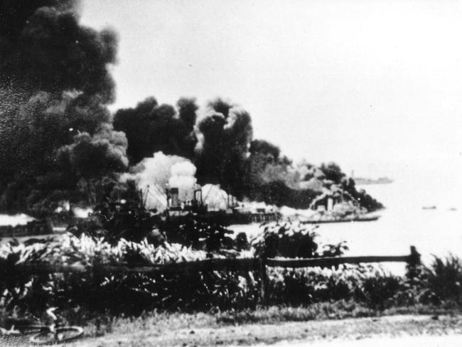 A photograph of the Darwin Harbour and the USS Peary up in smoke after the Japanese  bombing of  Darwin on February 19, 1942