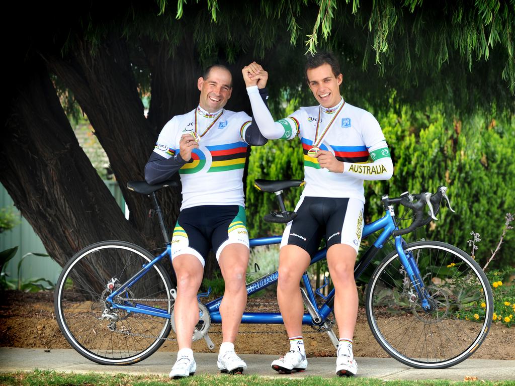 Kieran Modra with partner Scott McPhee after winning gold in Italy.