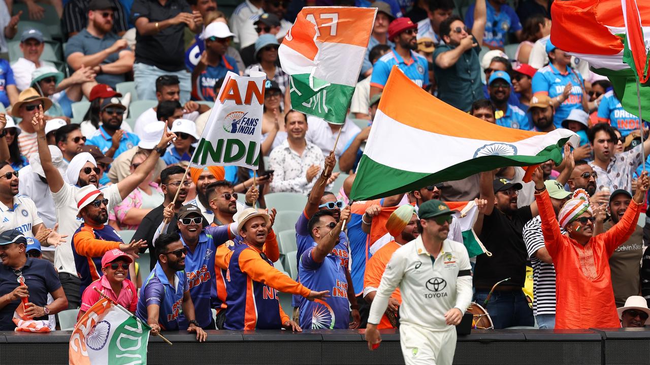 ADELAIDE, AUSTRALIA - DECEMBER 06: India fans celebrate after a boundary as Travis Head of Australia looks on in front during day one of the Men's Test Match series between Australia and India at Adelaide Oval on December 06, 2024 in Adelaide, Australia. (Photo by Paul Kane/Getty Images)