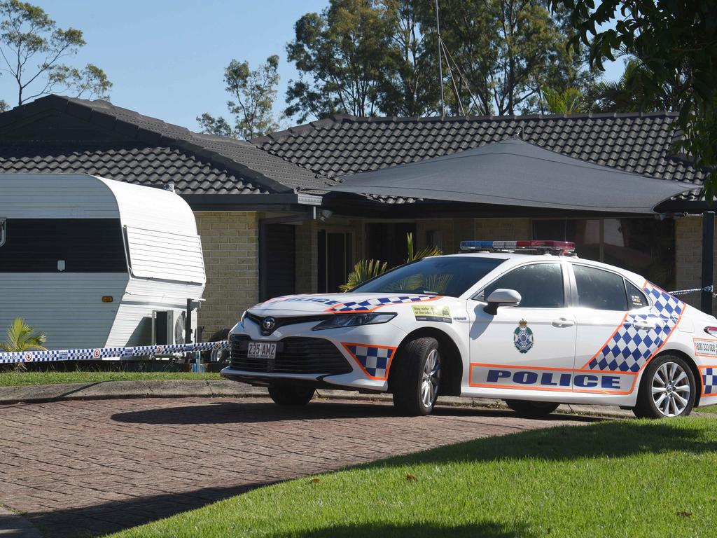 A dated caravan sits in the front yard at Spikes Court, Arundel where police tape surrounds the front perimeter and anyone who approaches the property is warned to move away. Picture: NCA NewsWire / Steve Holland