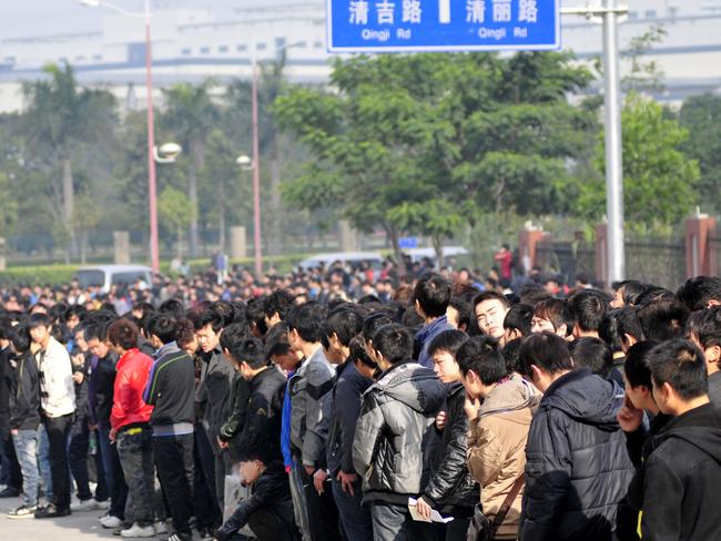 SHENZHEN, CHINA - FEBRUARY 13: (CHINA OUT) Applicants queue for an interview outside the Foxconn Qinghu recruitment centreon February 13, 2012 in Shenzhen, China. The recruitment centre for the technology company held a job fair on Monday, attracting many job seekers. According to reports, audits are to be conducted at Foxconn's factories in China following a request by Apple in the wake of criticism of working conditions. (Photo by VCG/VCG via Getty Images)