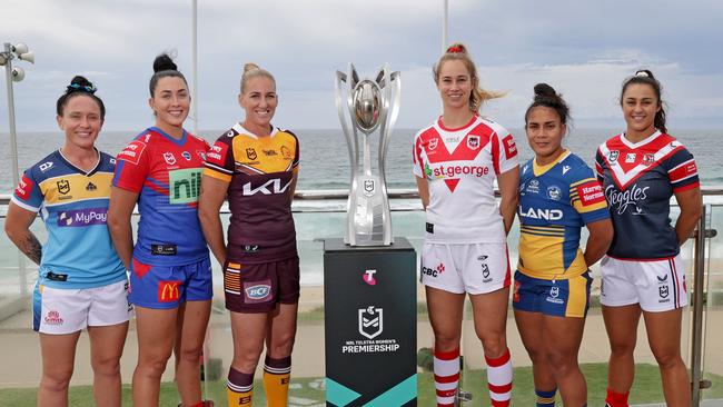 Captains Brittany Breayley-Nati (Titans), Romy Teitzel (Knights), Ali Brigginshaw (Broncos), Kezie Apps (Dragons), Simaima Taufa (Eels) and Corban Baxter (Roosters) with the NRLW premiership trophy. Picture: Toby Zerna