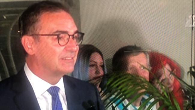 Premier Steven Marshall was giving his concession speech with a young red-haired woman in the background of the TV broadcast.