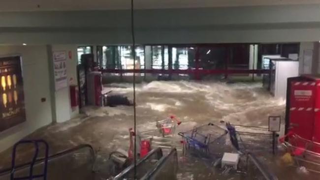 Floodwater breaks glass at shopping centre