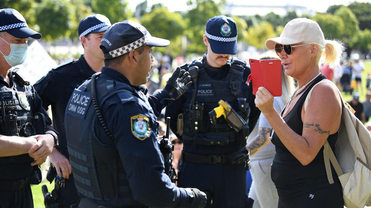 Police speak with a woman at a Freedom Day protest in Olympic Park, Sydney. Picture: NCA NewsWire/Joel Carrett.