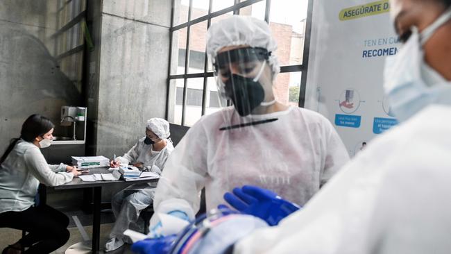 Health workers take part in random COVID-19 testing in Medellin, Colombia. Picture: AFP