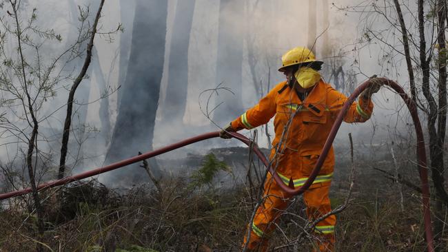 Fire crews fight a spot fire east of Nowa Nowa. Picture: David Crosling