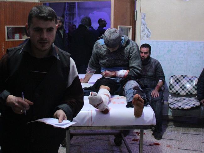 A wounded Syrian man sits on a gurney as victims pour into a makeshift hospital in the rebel-held town of Douma, following air strikes by regime forces on the besieged Eastern Ghouta region on the outskirts of Damascus. Picture: Hamza Al-Ajweh/AFP