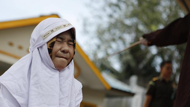 An Acehnese woman is whipped in front of the public for violating sharia law in Banda Aceh, Indonesia, 27 February 2017. The woman was whipped for having a sex without being married. Picture: Hotli Simanjuntak