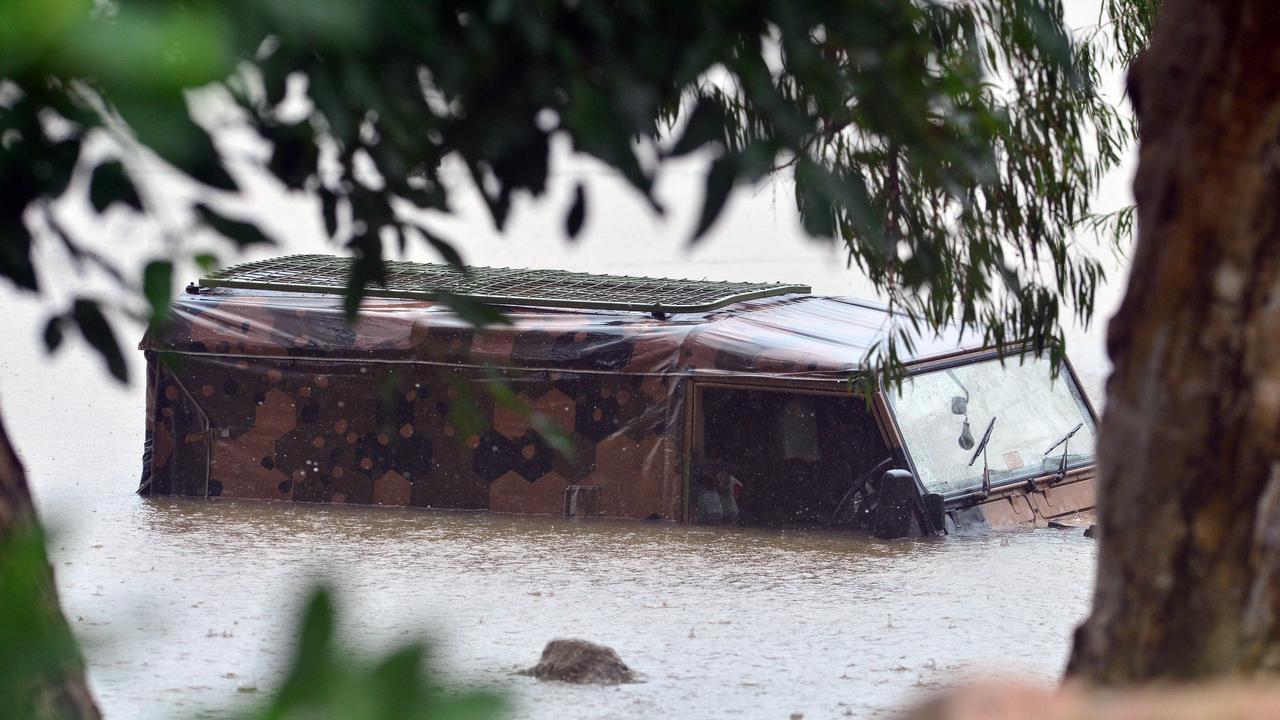 A man drove his car into flood waters at Loam Island, Rasmussen. Picture: Zak Simmonds