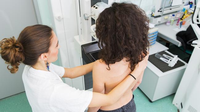 Nurse with young women having a mammography