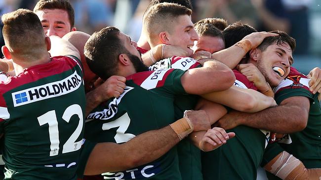 Lebanon players mob Mitchell Pearce after his individual piece of brilliance.