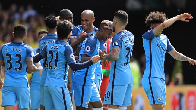 Manchester City players celebrate a goal.
