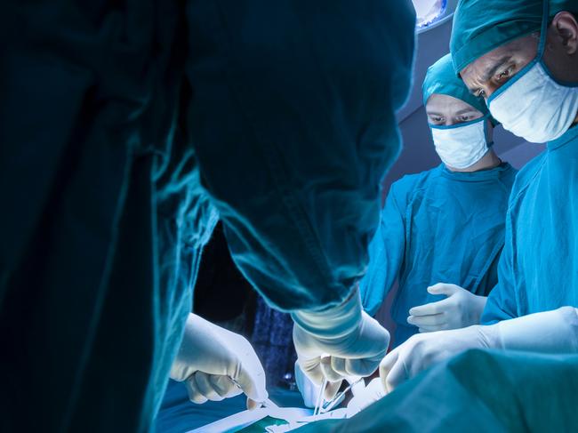 concentrated professional surgical doctor team operating surgery a patient in the operating room at the hospital. healthcare and medical concept."n