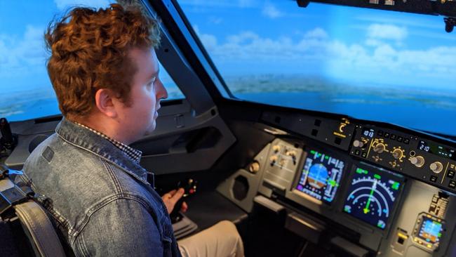 Tobi Loftus has a go on the A320 flight simulator at USQ