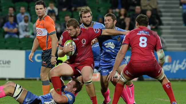 Queensland Reds captain James Slipper is tackled by the Force.