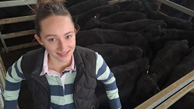 Rosie Hunt with family steers which sold for $1210 on weight of 282kg. Picture: Jenny Kelly