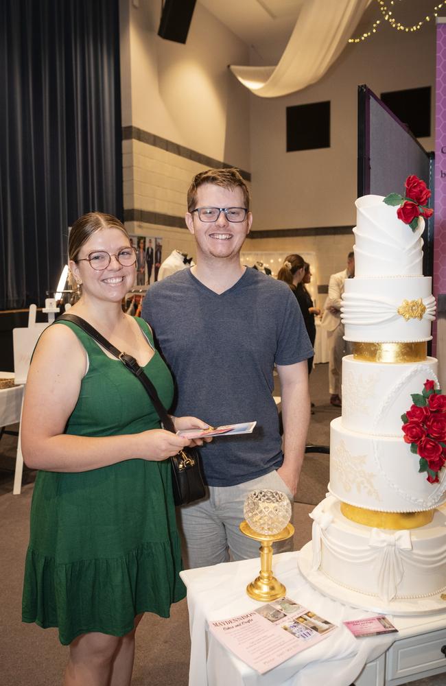 Engaged couple Molly Webster and Sam Turner appreciate a wedding cake by Maydennison on show at Toowoomba's Wedding Expo hosted by Highfields Cultural Centre, Sunday, January 21, 2024. Picture: Kevin Farmer