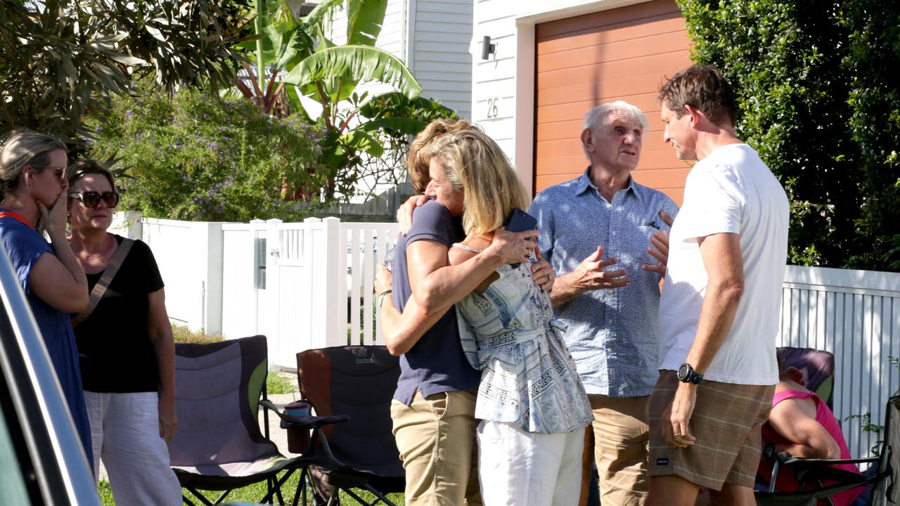 Family and friends hug at the scene. Picture: Steve Pohlner