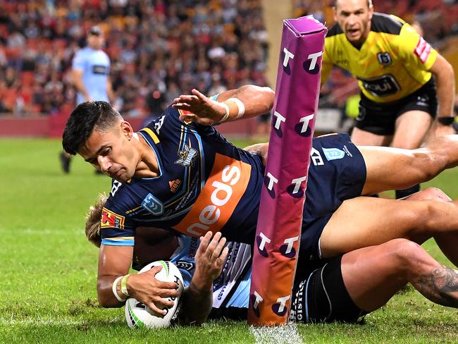 BRISBANE, AUSTRALIA - MAY 09: Jesse Arthars of the Titans is taken over the sideline as he attempts to score a try during the round nine NRL match between the Gold Coast Titans and the Cronulla Sharks at Suncorp Stadium on May 09, 2019 in Brisbane, Australia. (Photo by Bradley Kanaris/Getty Images)