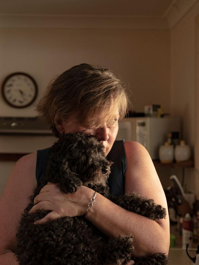 AUS MAG. Portrait of Tracey Campbell with their dog Toby in her husbands fathers house which survived the fires whilst 2 next door neighbours lost theirs. Pic by Nic Walker. For a story by Trent Dalton. Date 14th Feb 2019