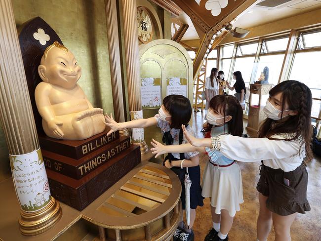 Visitors wear face masks at Tsutenkaku tower in Osaka. Picture: AFP