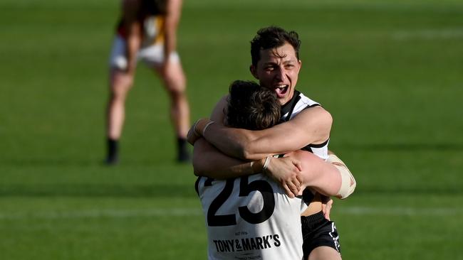 Falcons players Patrick Levicki and Nick Jolly embrace after the final siren. Picture: Naomi Jellicoe