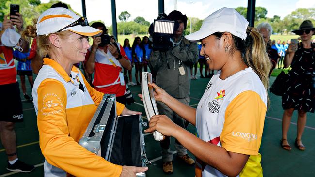 Darwin born singer Jessica Mauboy is handed the Queen's Baton during its journey through Darwin.