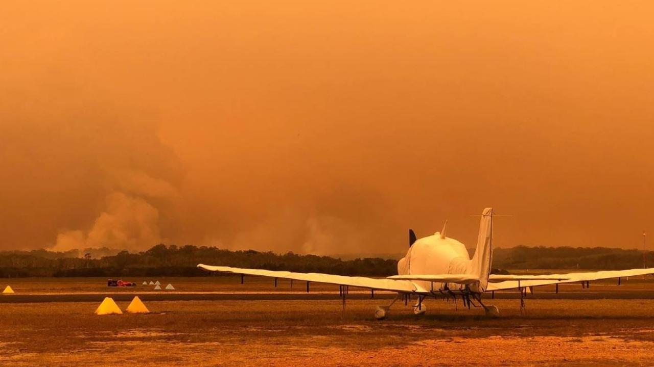 A plane on the tarmac at Port Macquarie Airport, which has been impacted by low visibility due to bushfire smoke.